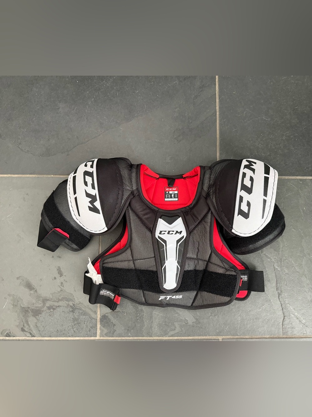 Boys CCM red and black hockey chest pad.